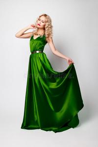 美丽的女人模特穿着绿色的衣服摆姿势照片